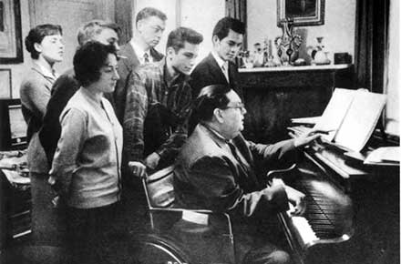 Darius Milhaud with students at piano